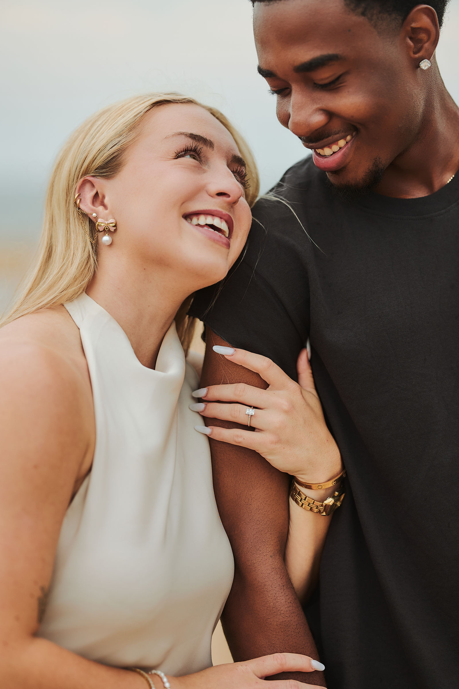 Newly engaged couple laughing together — engagement photography by Thyzfoto